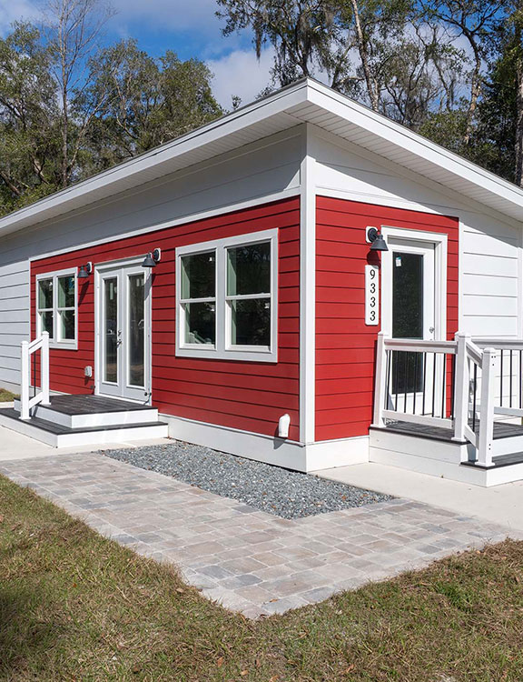 Red cottage home with white trim 